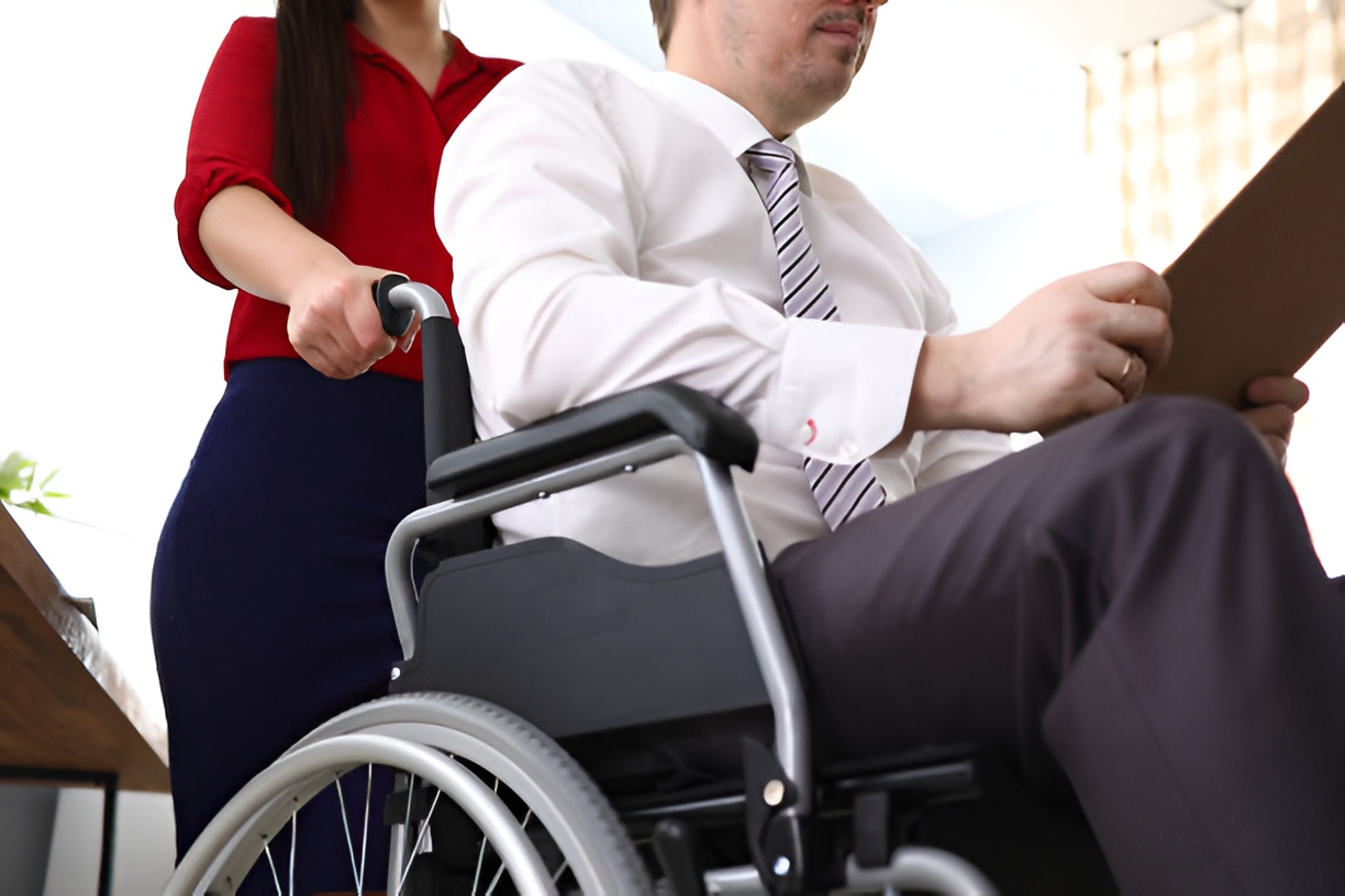 man in a wheelchair reading a document