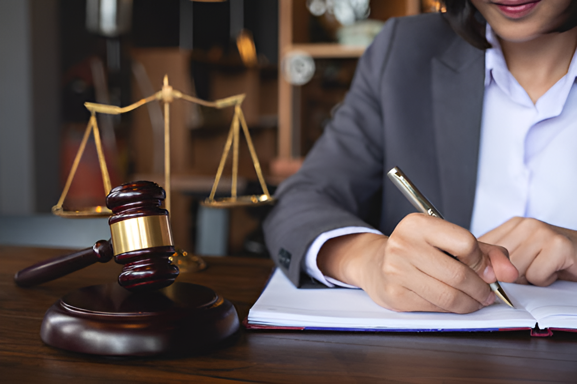 lawyer working at a desk with a gavel and a balancing scale