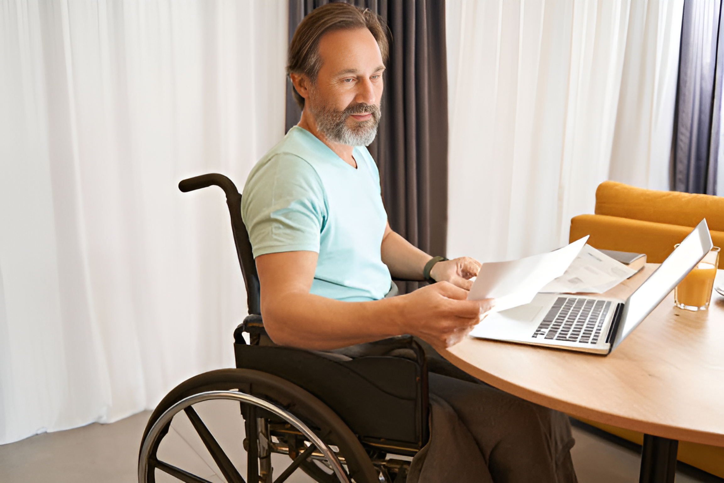 man in a wheelchair reading a document